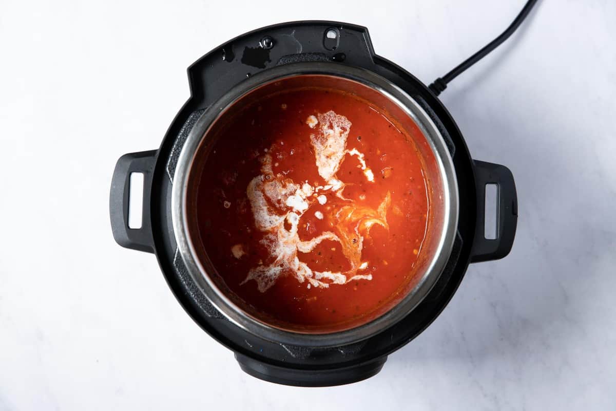 tomato soup with splashes of heavy cream swirled in.