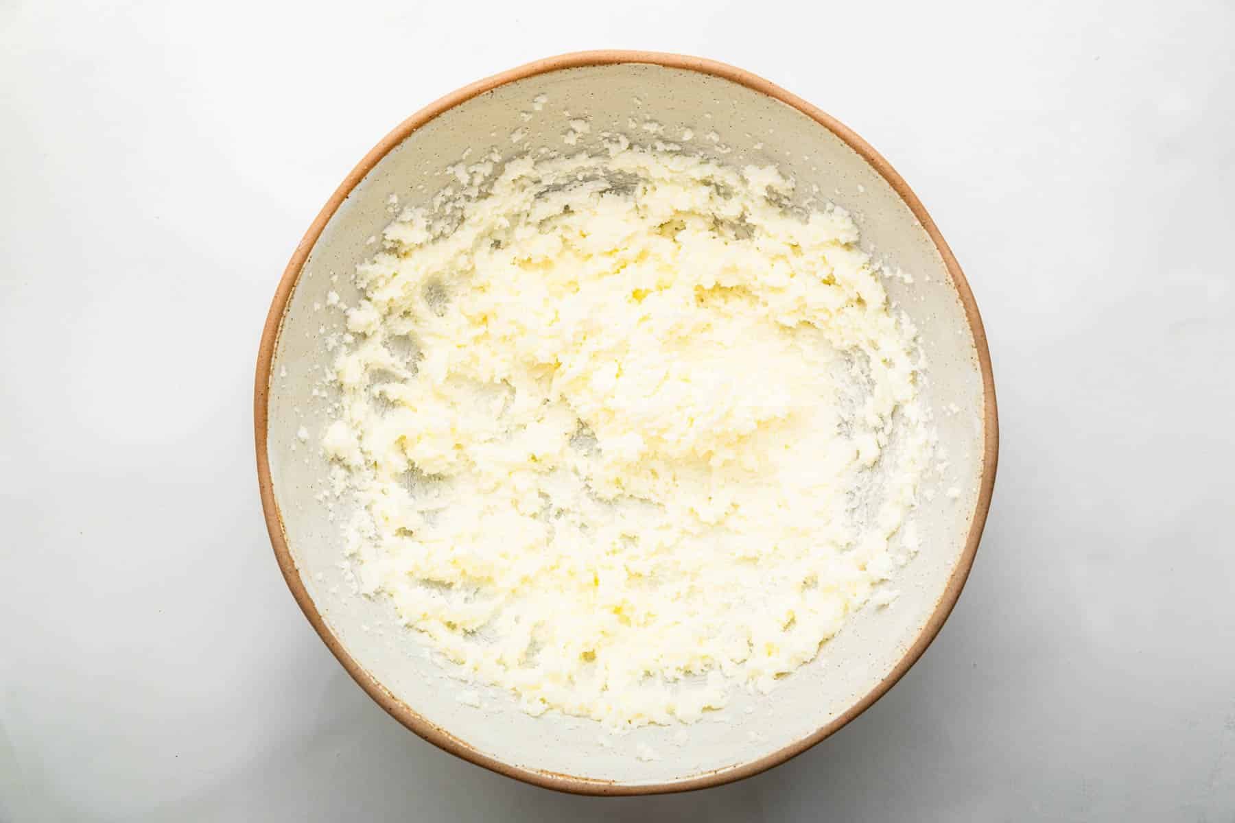 Shallow bowl with fluffy butter in it.