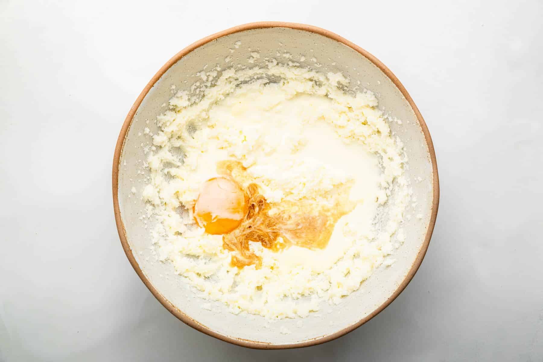 Batter with egg and vanilla splashed on top.