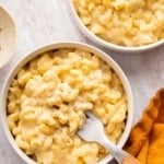 Two bowls of Mac and cheese with a fork in one bowl.