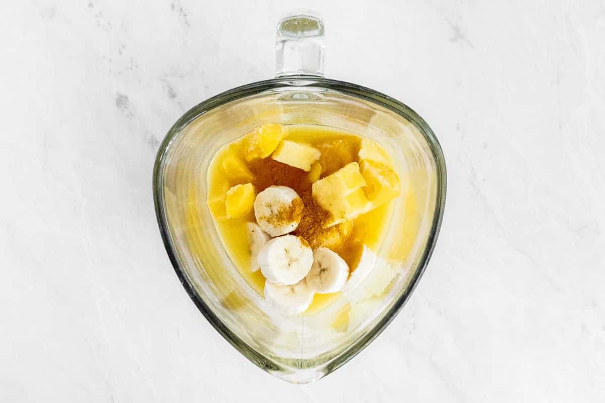 Diced fruit in blender cup.