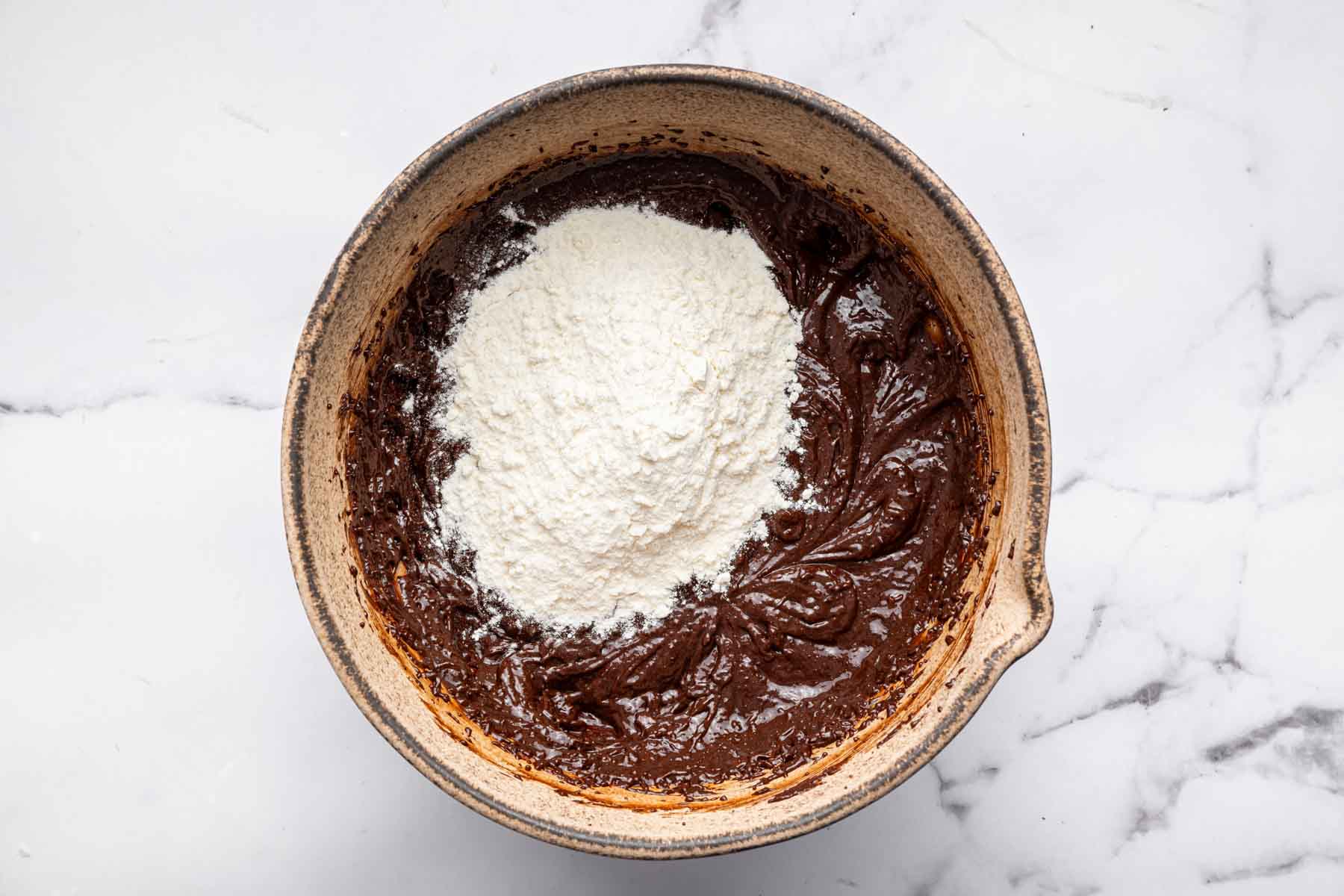 Chocolate batter with flour dumped on top.