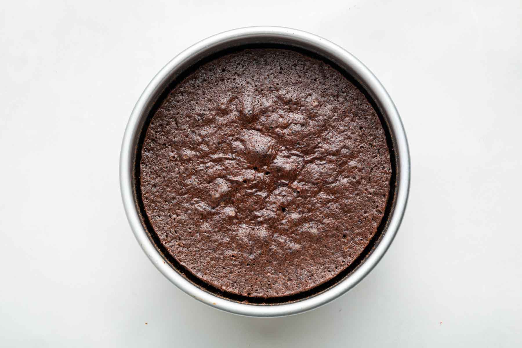 Freshly baked mini chocolate cake in a 6 inch pan.