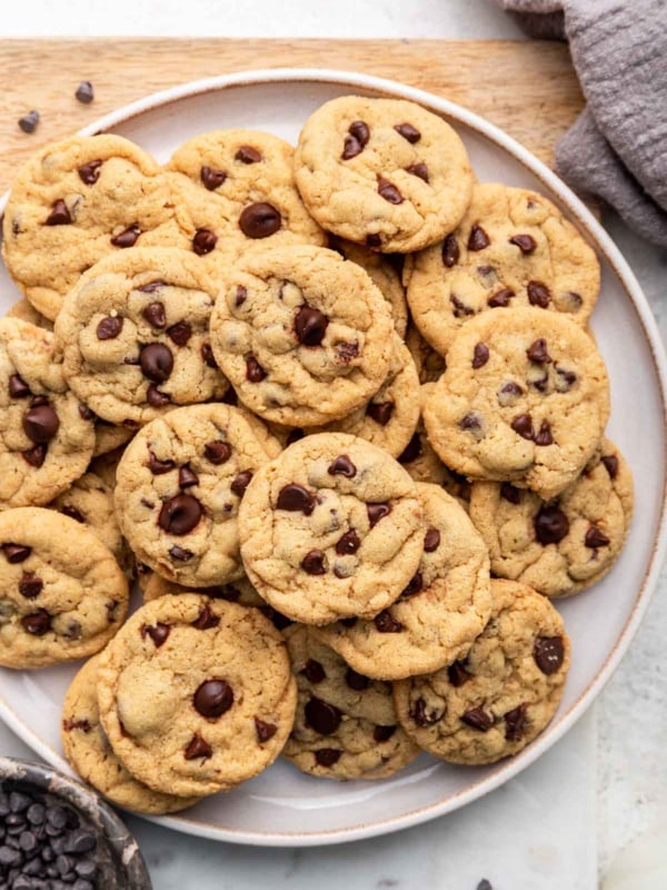 Macro shot of mini chocolate chip cookies on a plate with rim.