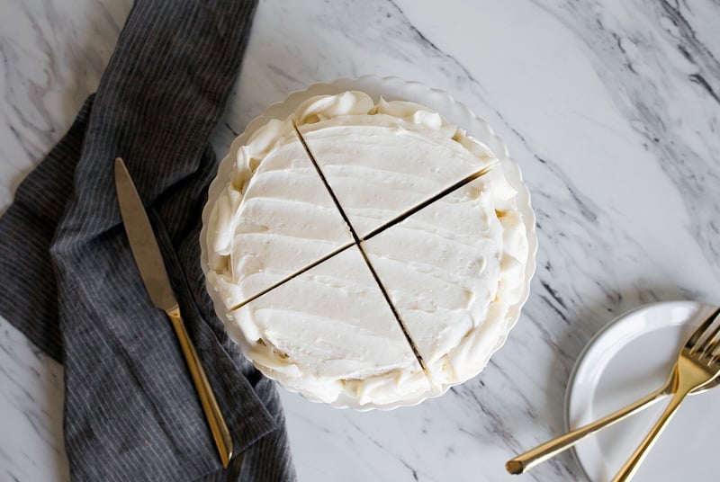 Mini Vanilla Cake for Two people in a 6" small round cake pan. Vanilla buttercream roses on the sides.