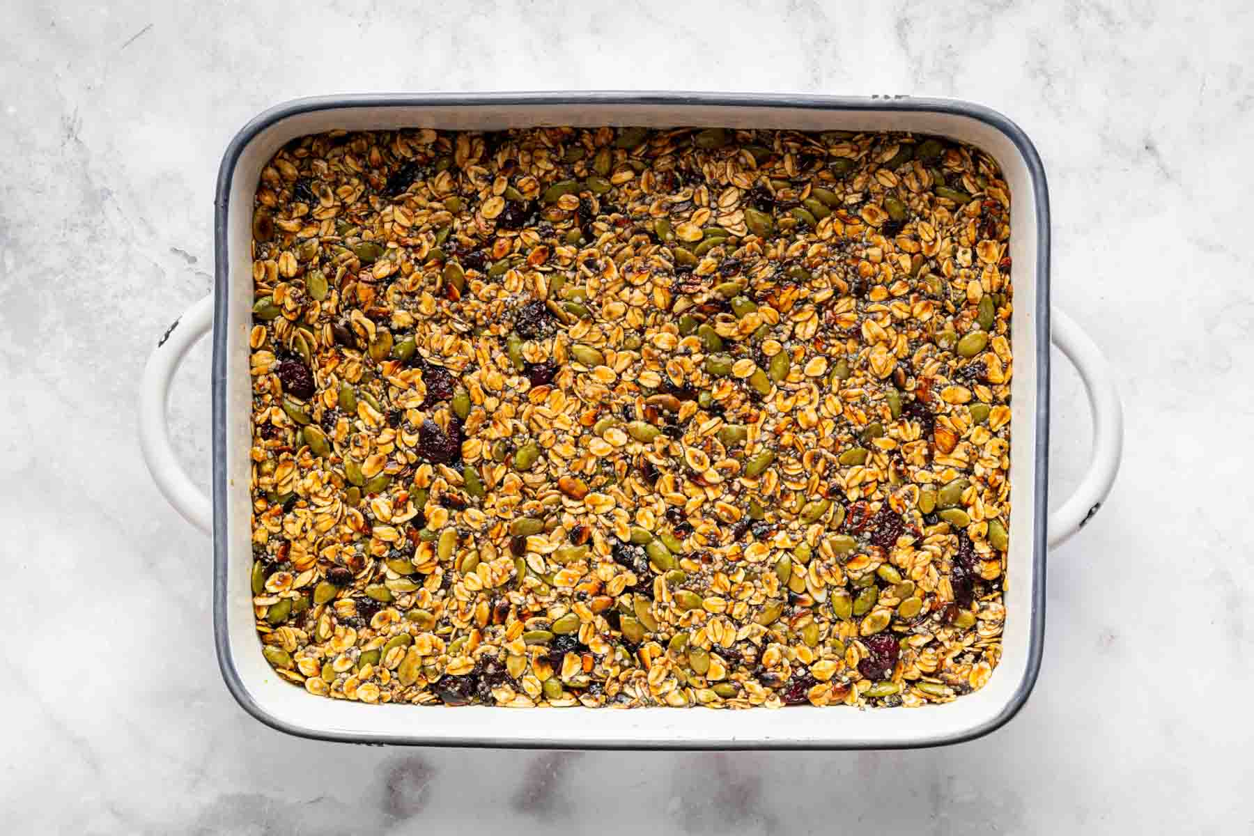 Baking tray packed with no bake granola bars on kitchen counter.