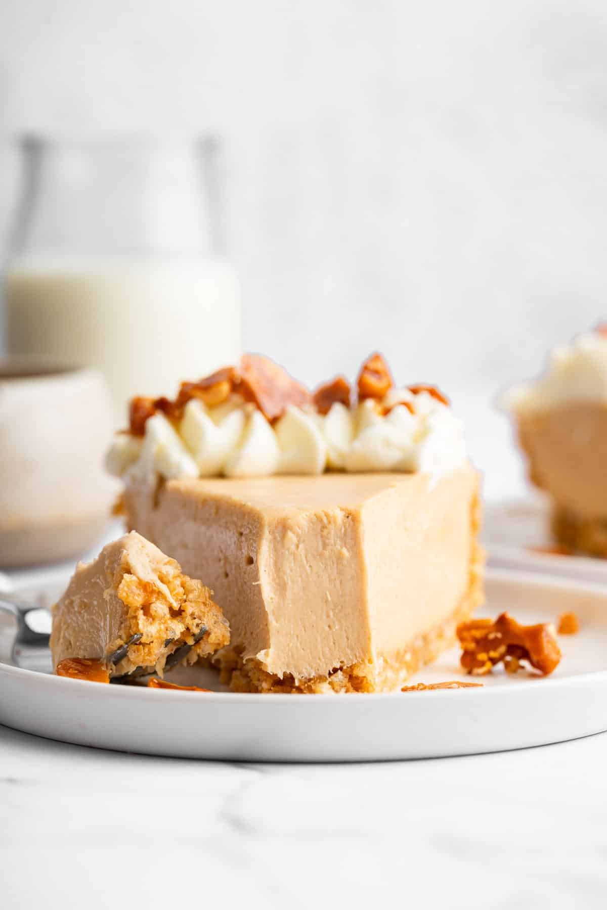 Macro image of creamy tan dessert with bite missing.