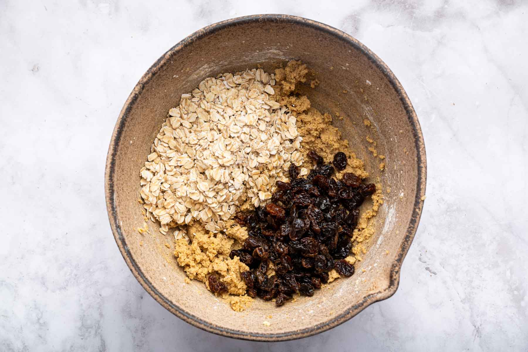 Brown batter with oats and soaked raisins on top.