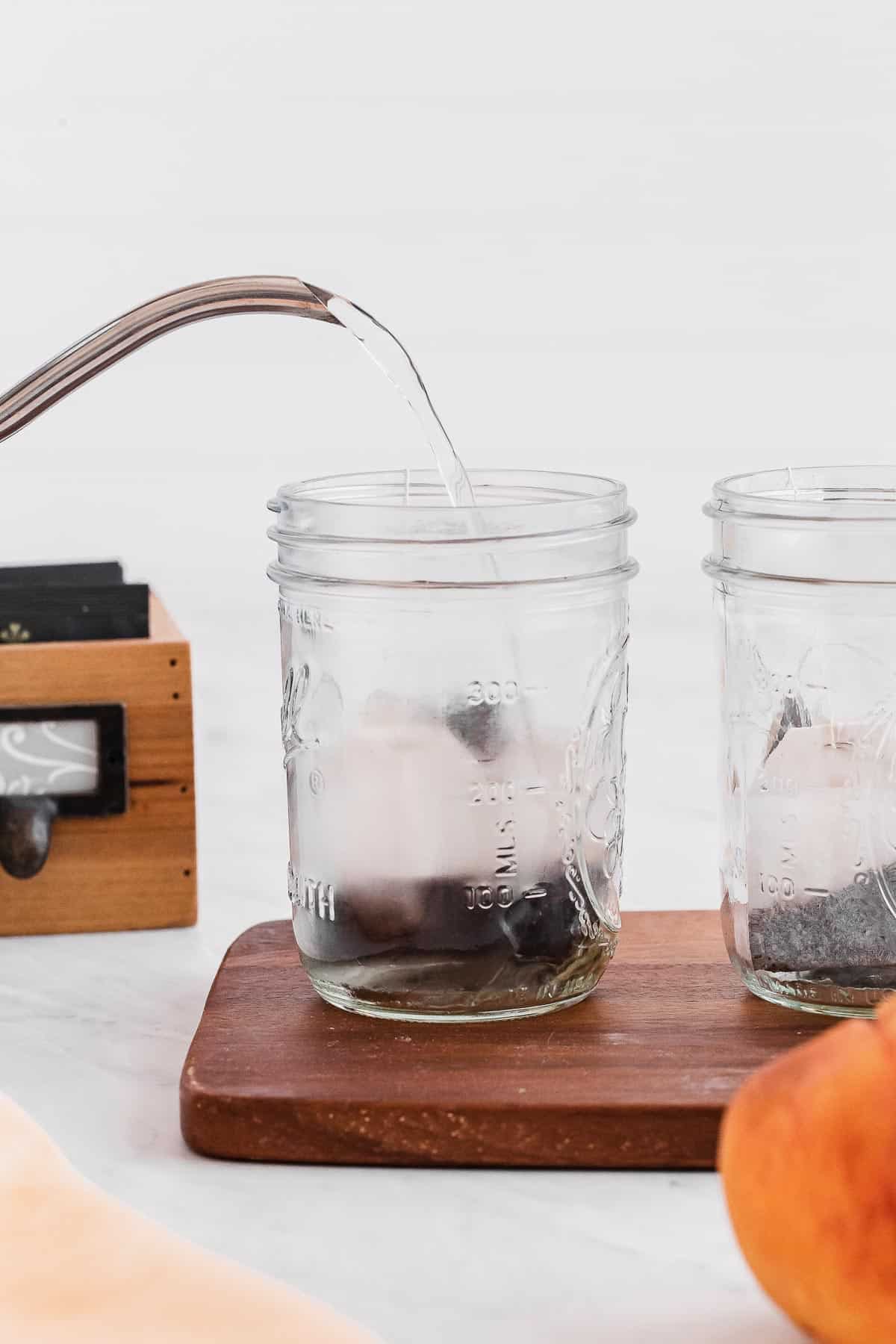 Boiling water being poured over tea bag.