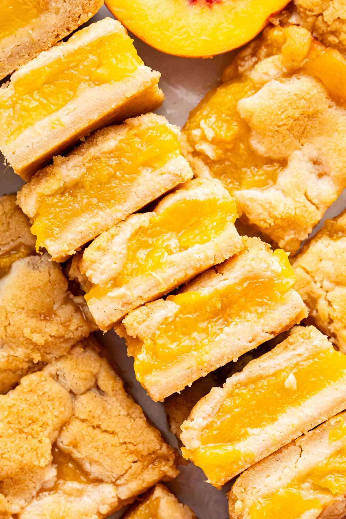 Diagonal stack of peach bars sliced and showing their fruit filling.