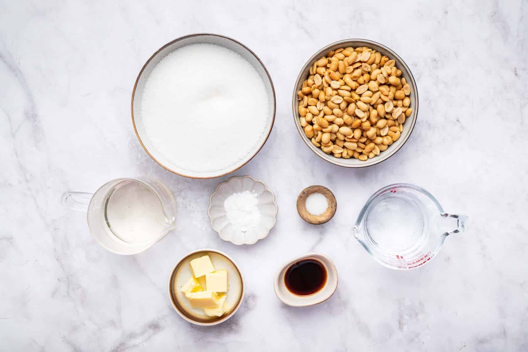 Small bowls of sugar, peanuts, butter, vanilla and water.