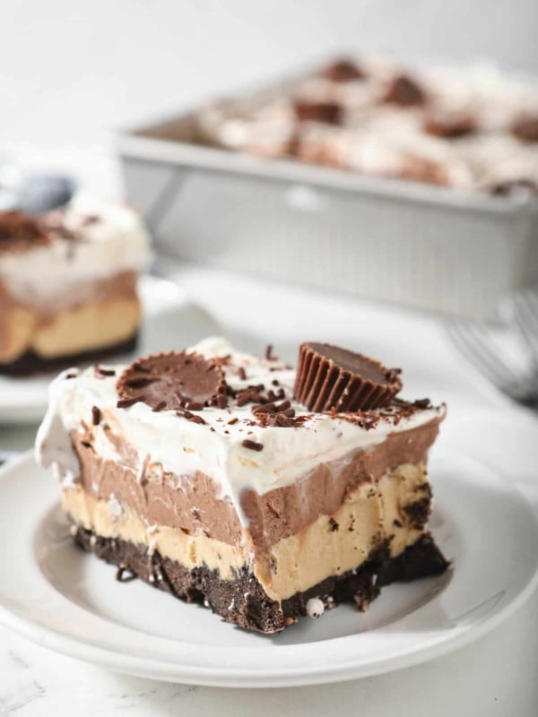 Slice of chocolate peanut butter lasagna on a white plate.