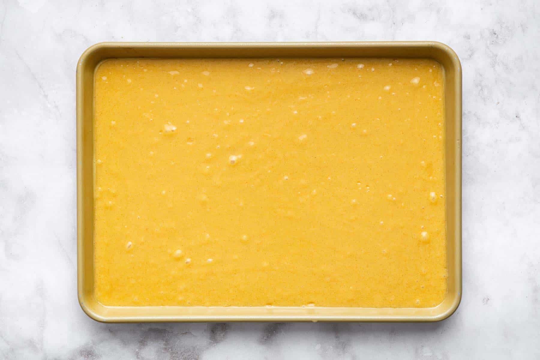 Brown liquid batter in rectangular pan.