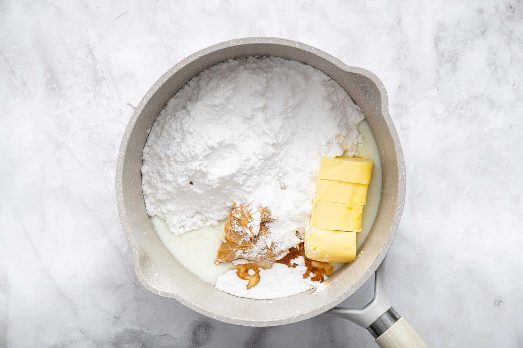 Small saucepan with powdered sugar, butter and peanut butter.