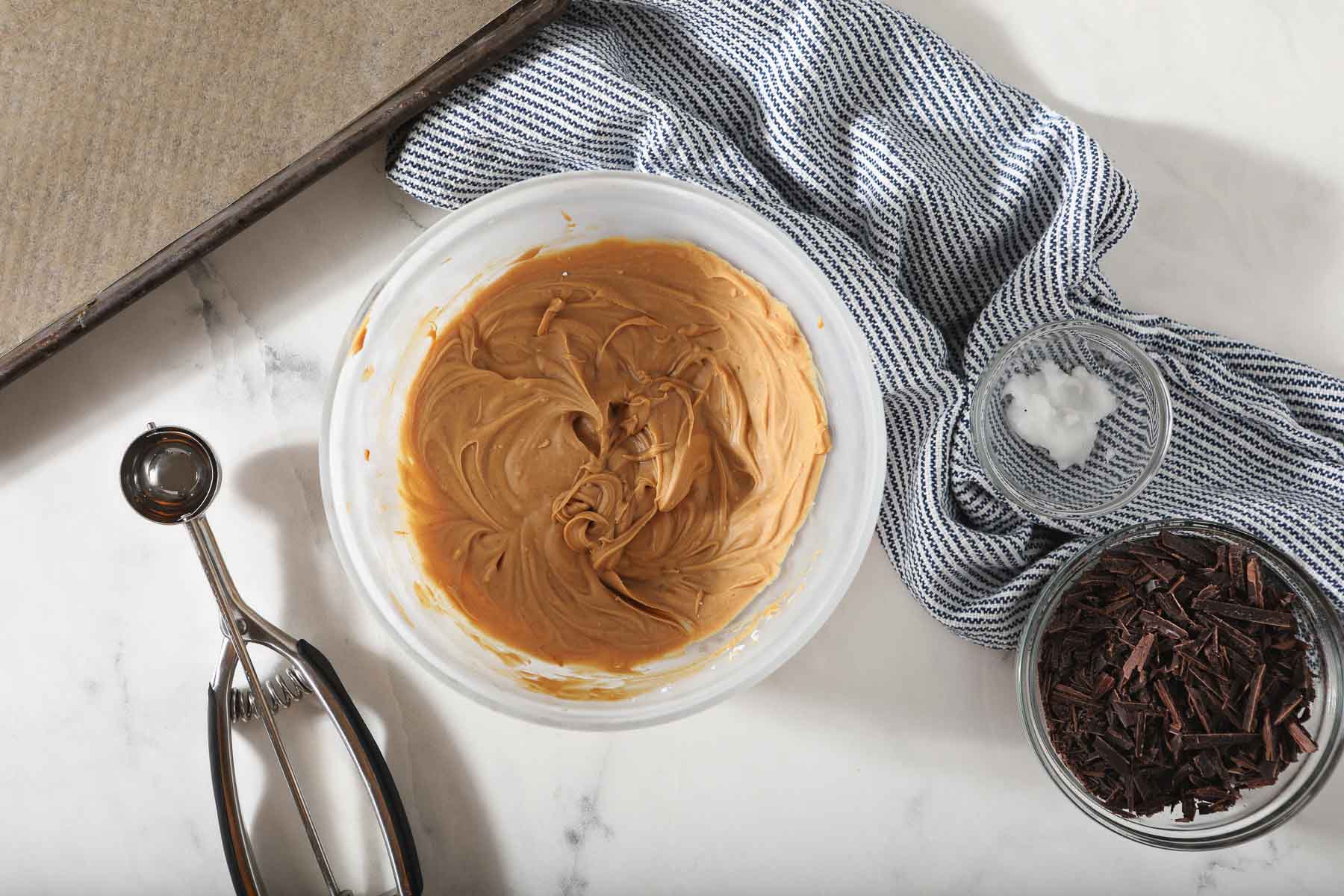 Frozen peanut butter truffles in glass bowl.