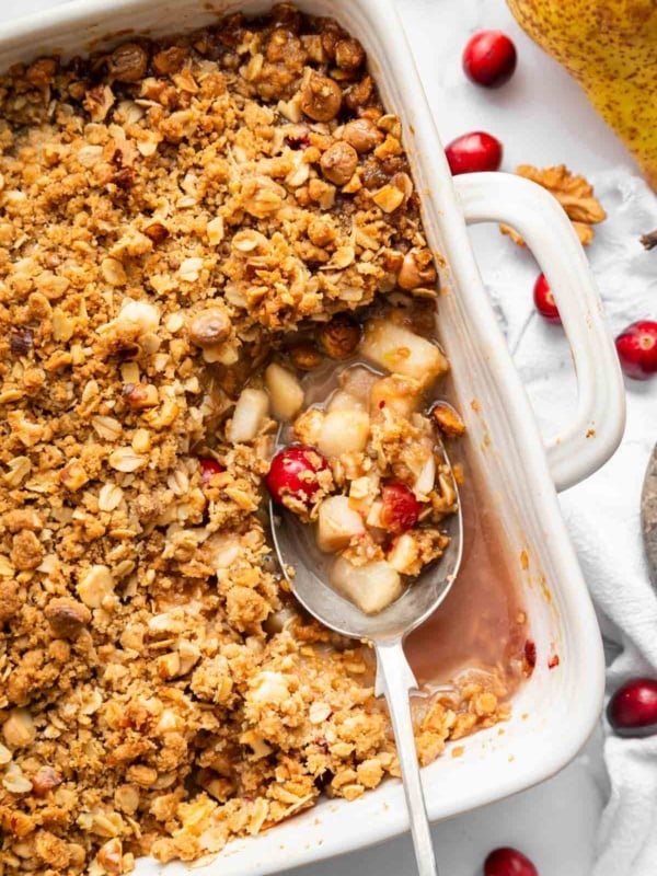 Overhead shot of pear cobbler in a square dish with cranberries.