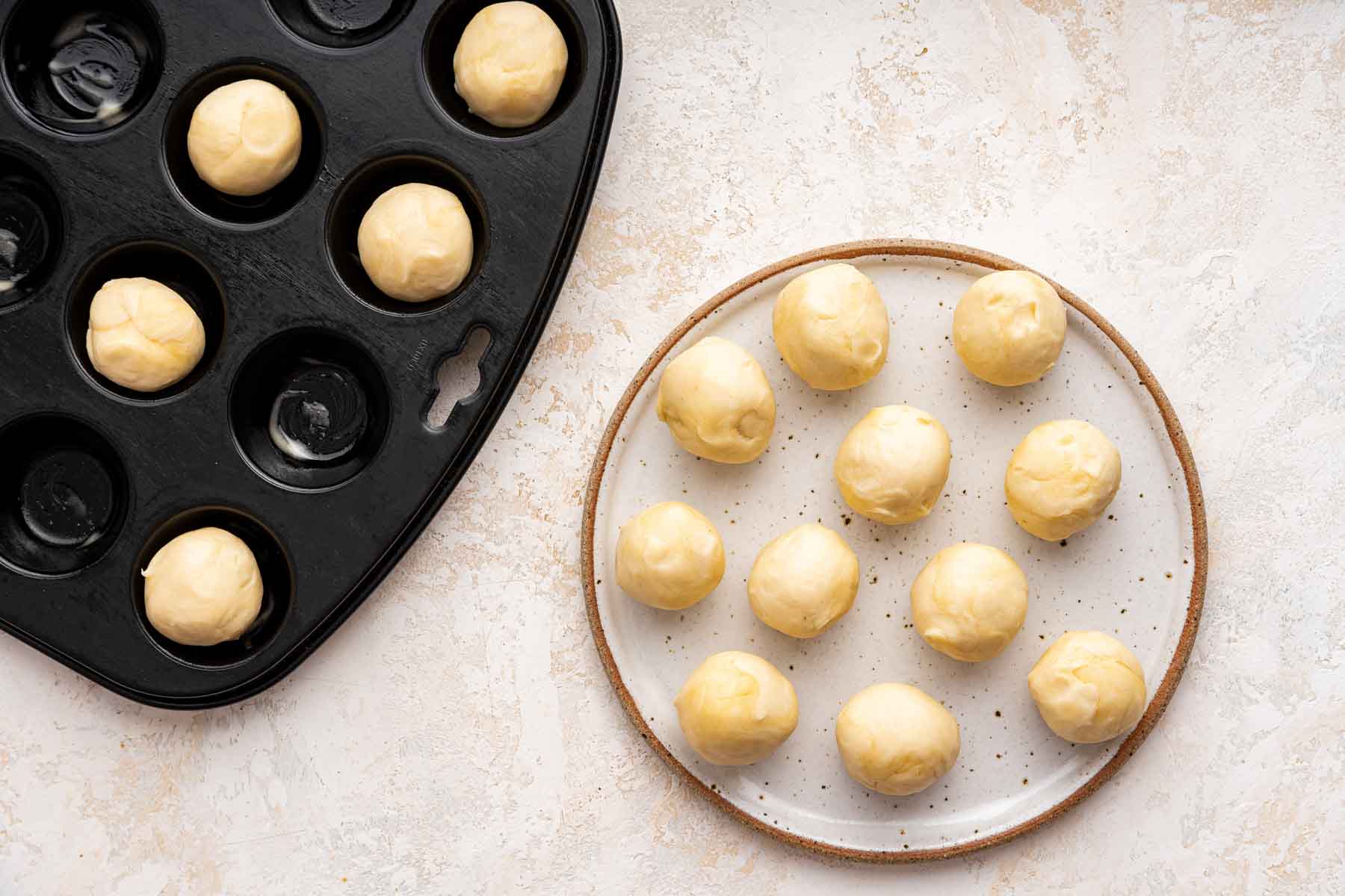 Balls of dough on plate and in mini muffin pan.