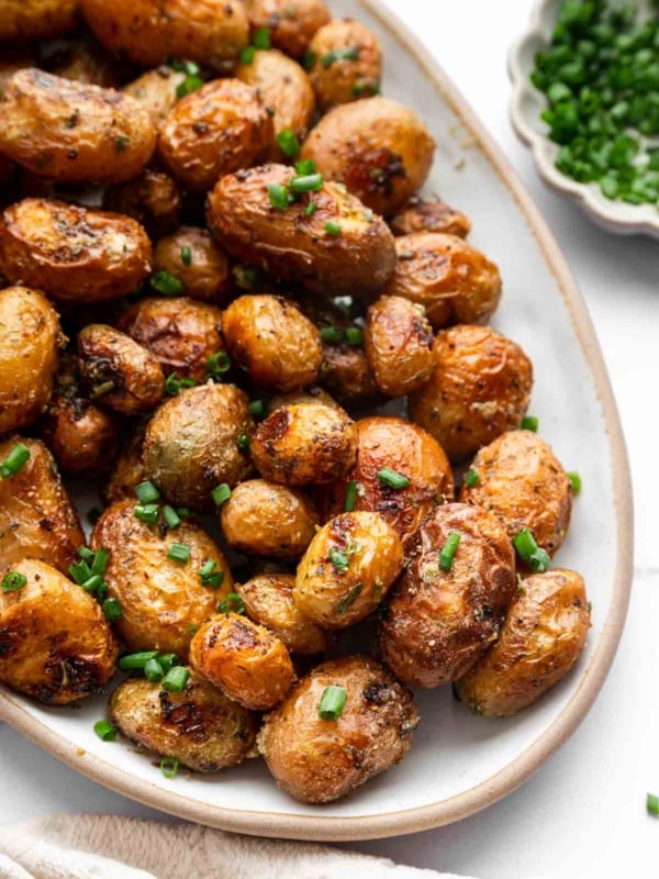 Hero image of roasted ranch potatoes on oval platter.