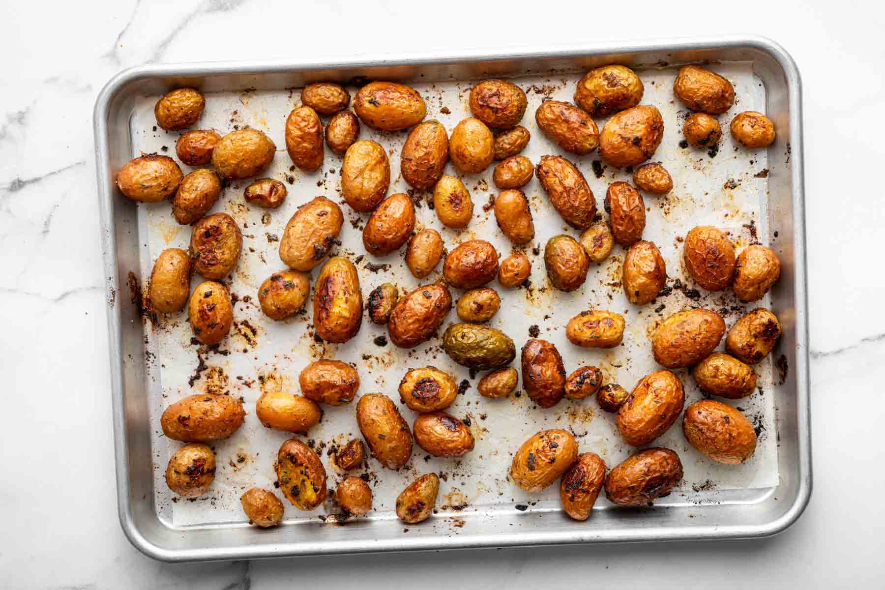 Horizontal image of roasted vegetables on baking sheet.
