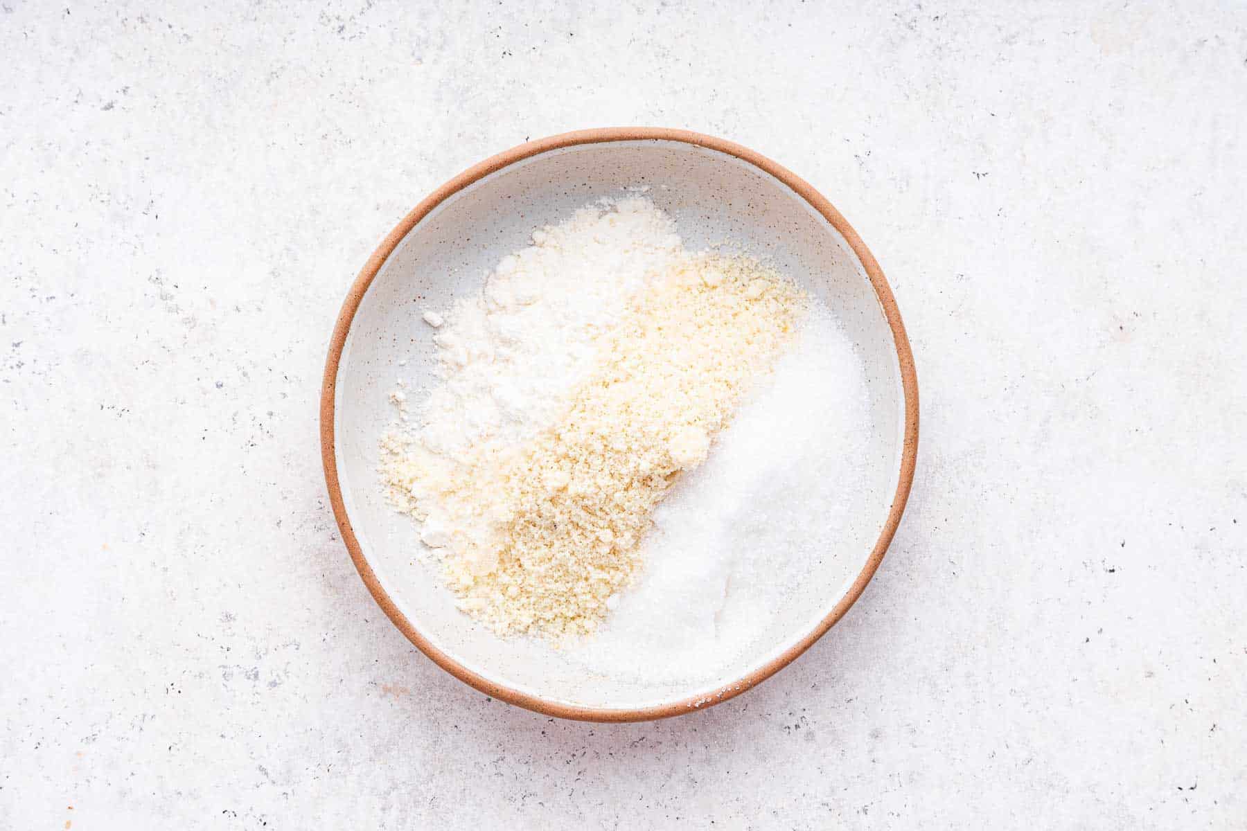 Shallow bowl with almond flour, sugar, and regular flour.