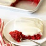 Close up of red velvet sheet cake on plate with fork.