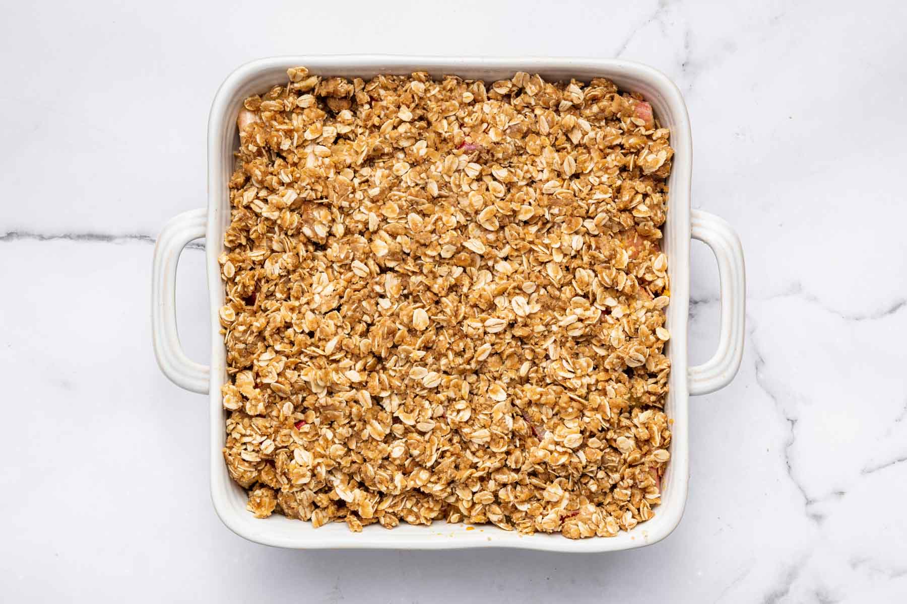 Square baking dish with oat streusel topping.