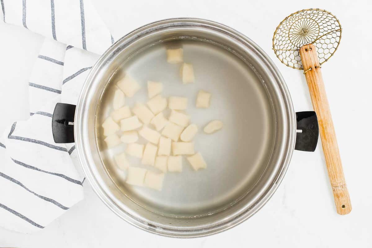 Ricotta gnocchi boiling in stock pot.