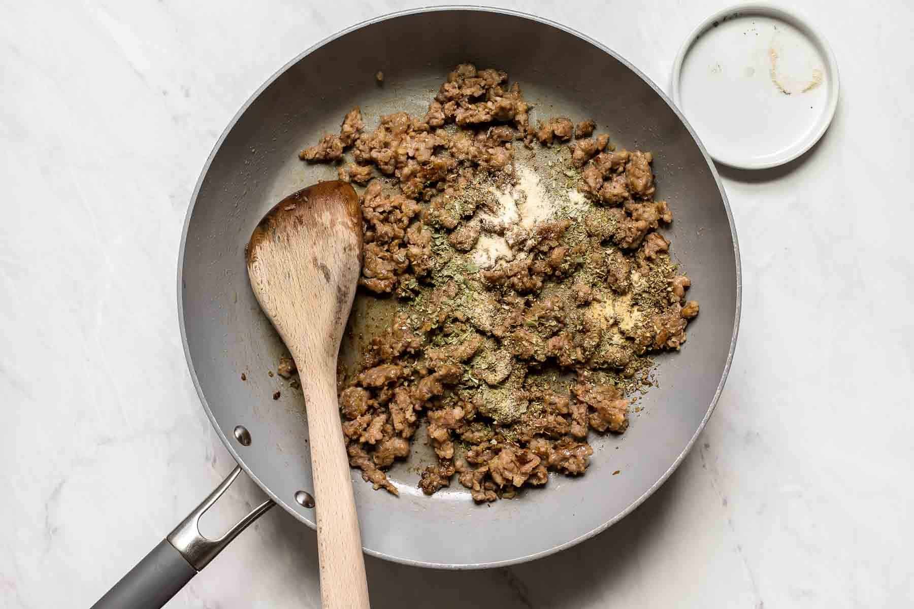 Sausage browning in a skillet.