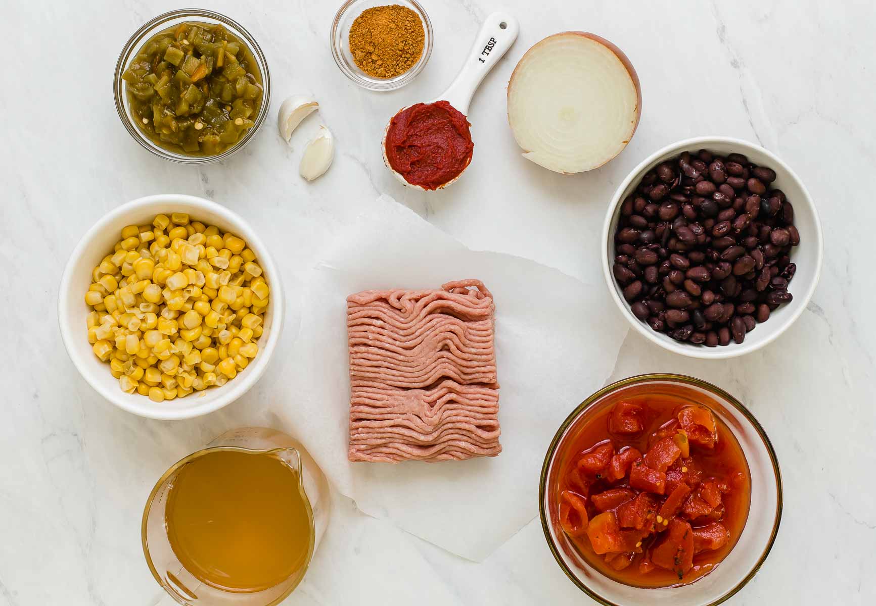 Ingredients for slow cooker taco soup with turkey in little bowls on the counter.