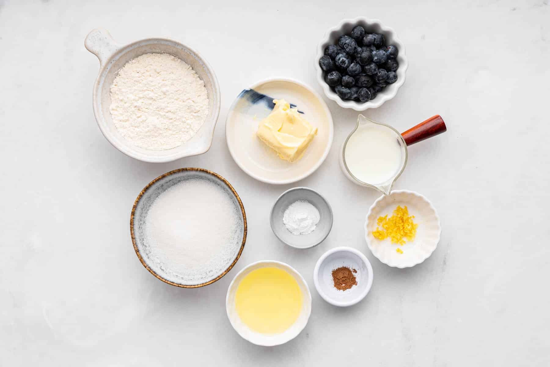 Small bowls with butter, fruit, vanilla, and flour.