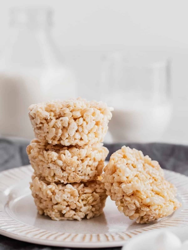 four rice krispies cups stacked on a plate