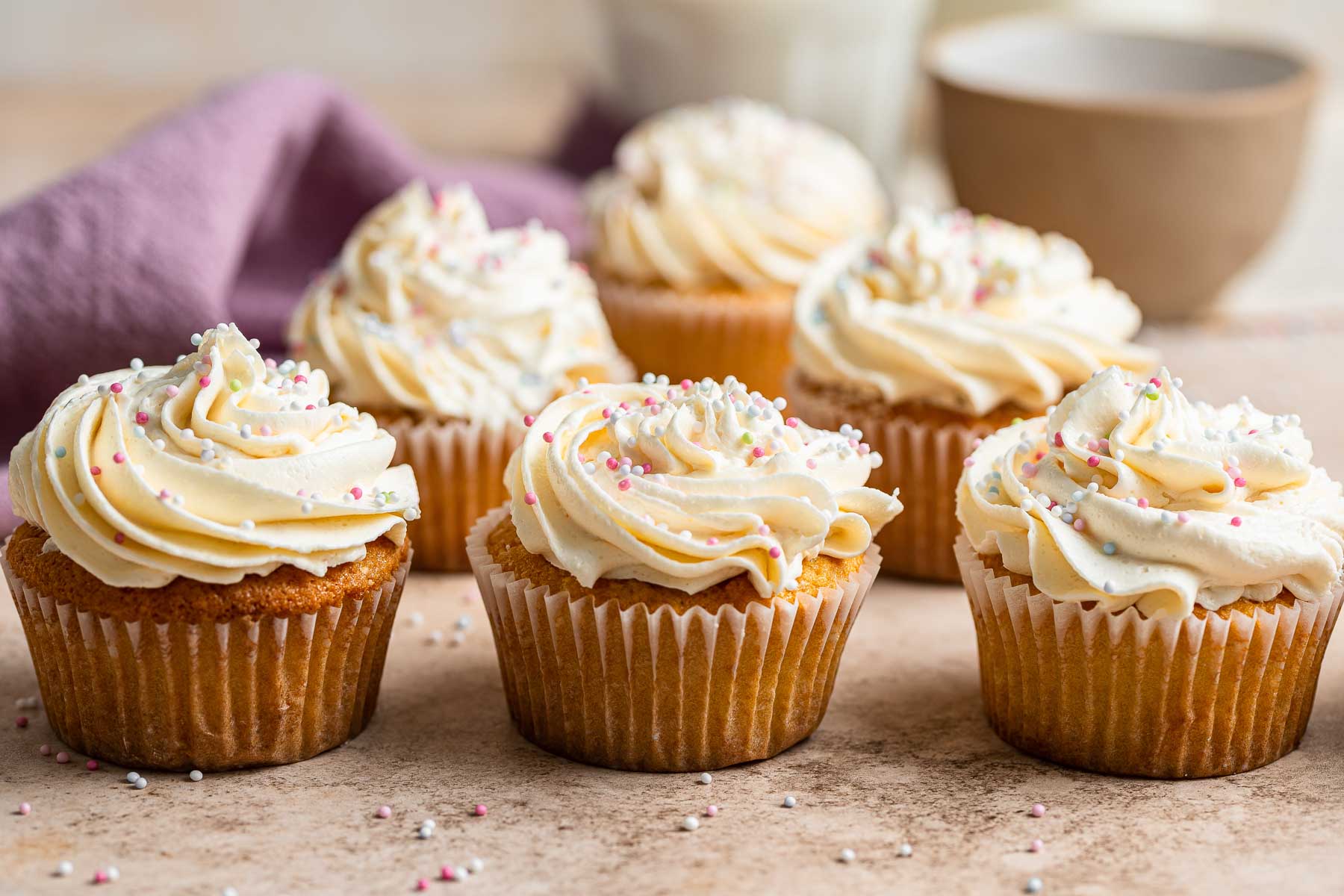 Small batch vanilla cupcakes on table top.