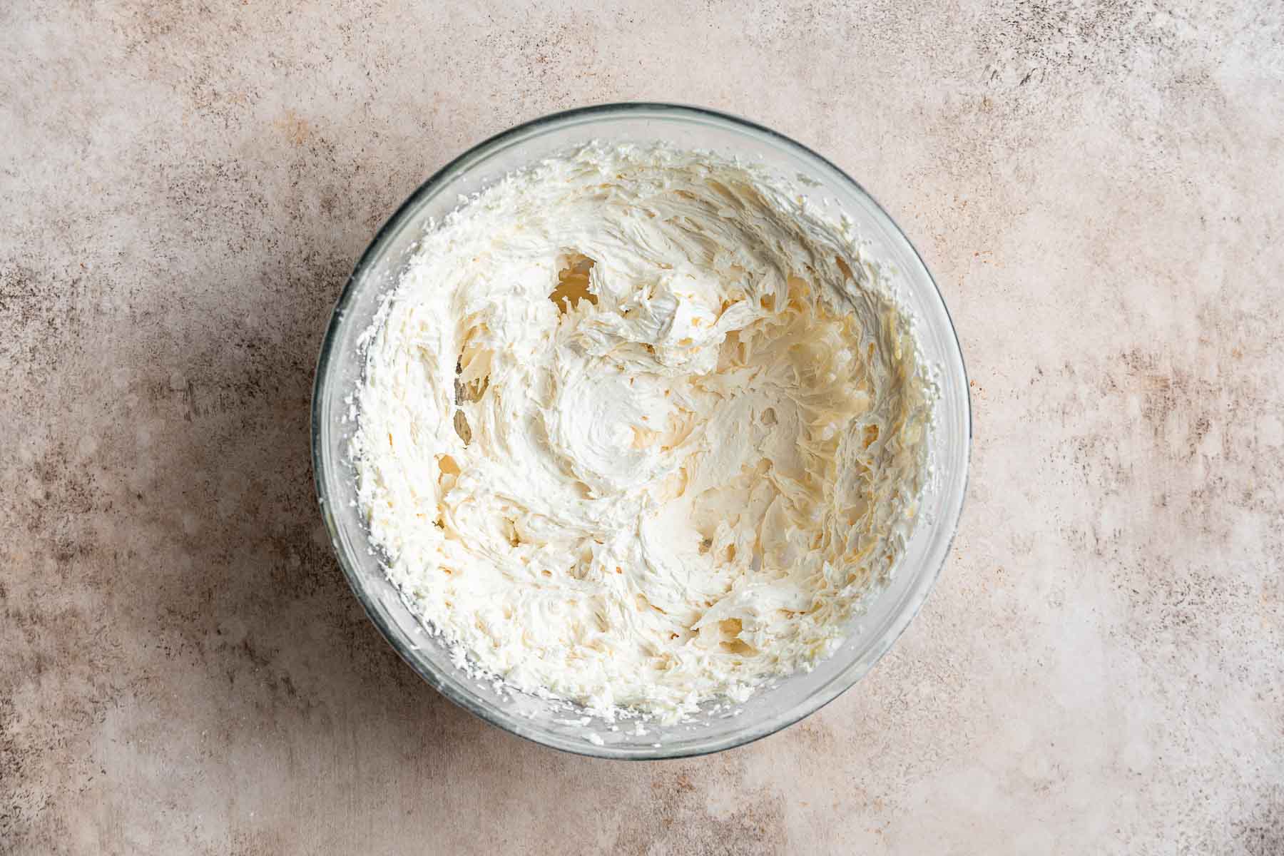 Fluffy white frosting in a bowl.