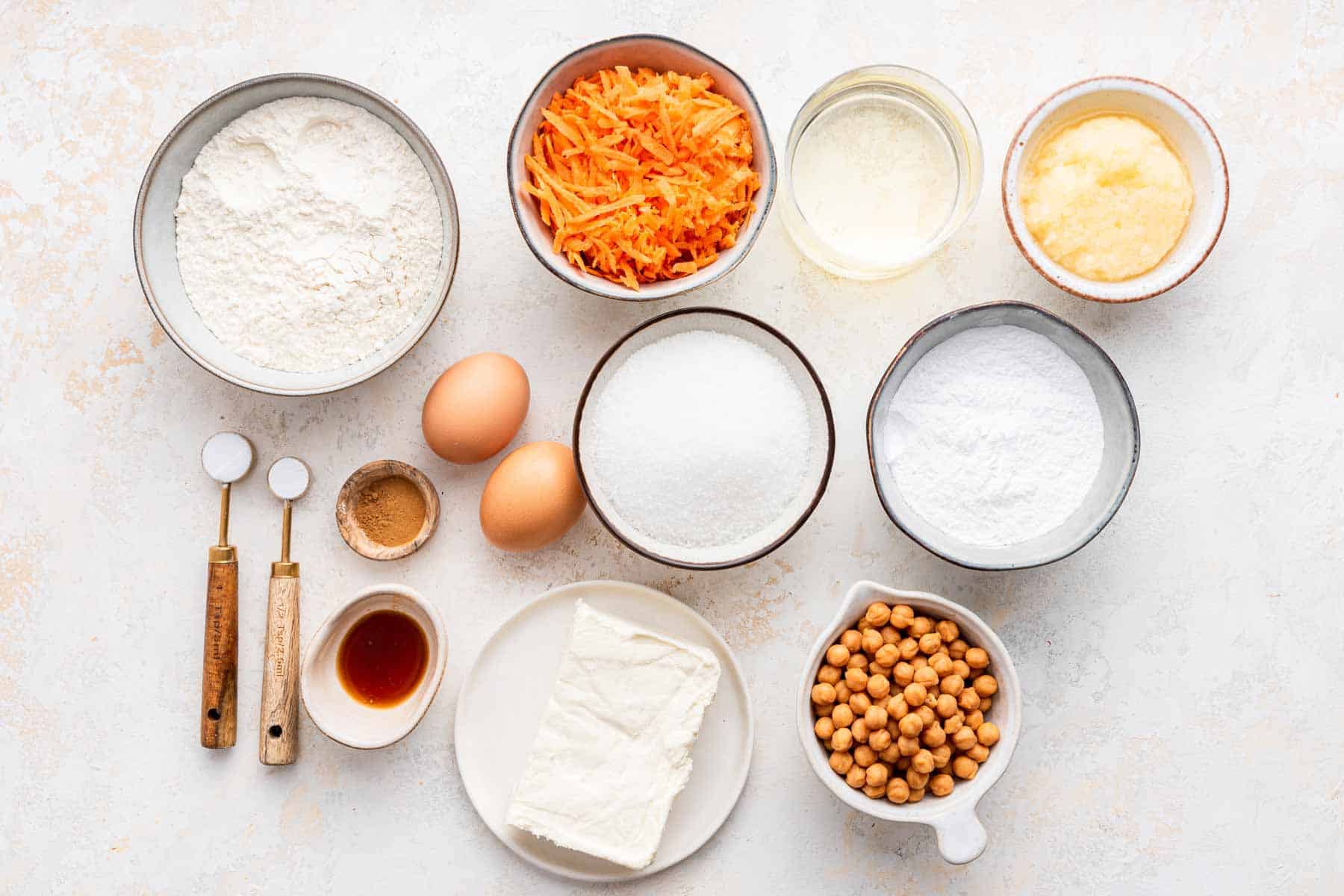 Small bowls of baking ingredients on a marble counter.