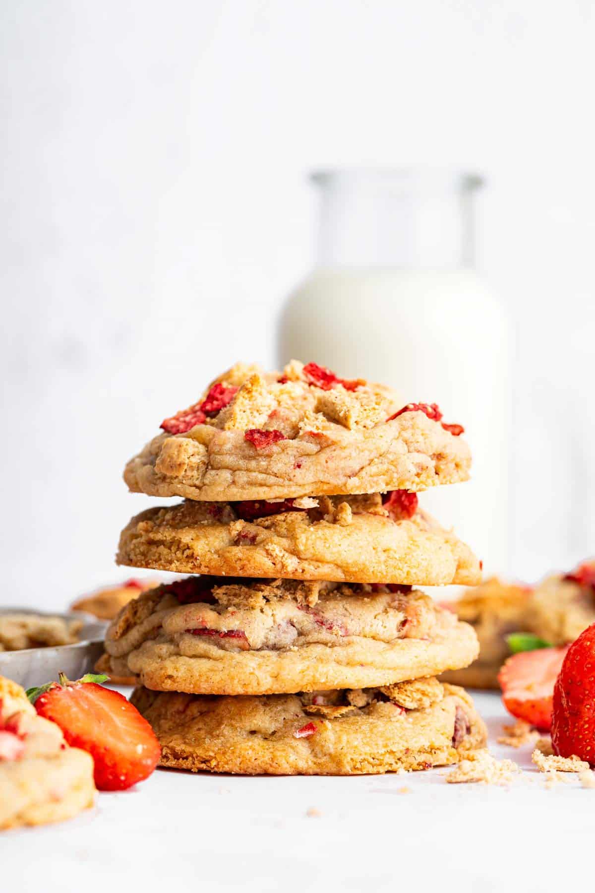 Stack of cookies with strawberries and graham crackers on the side.