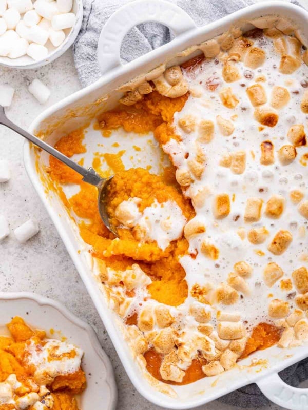 Sweet potato casserole with marshmallows in 8 inch square casserole dish.