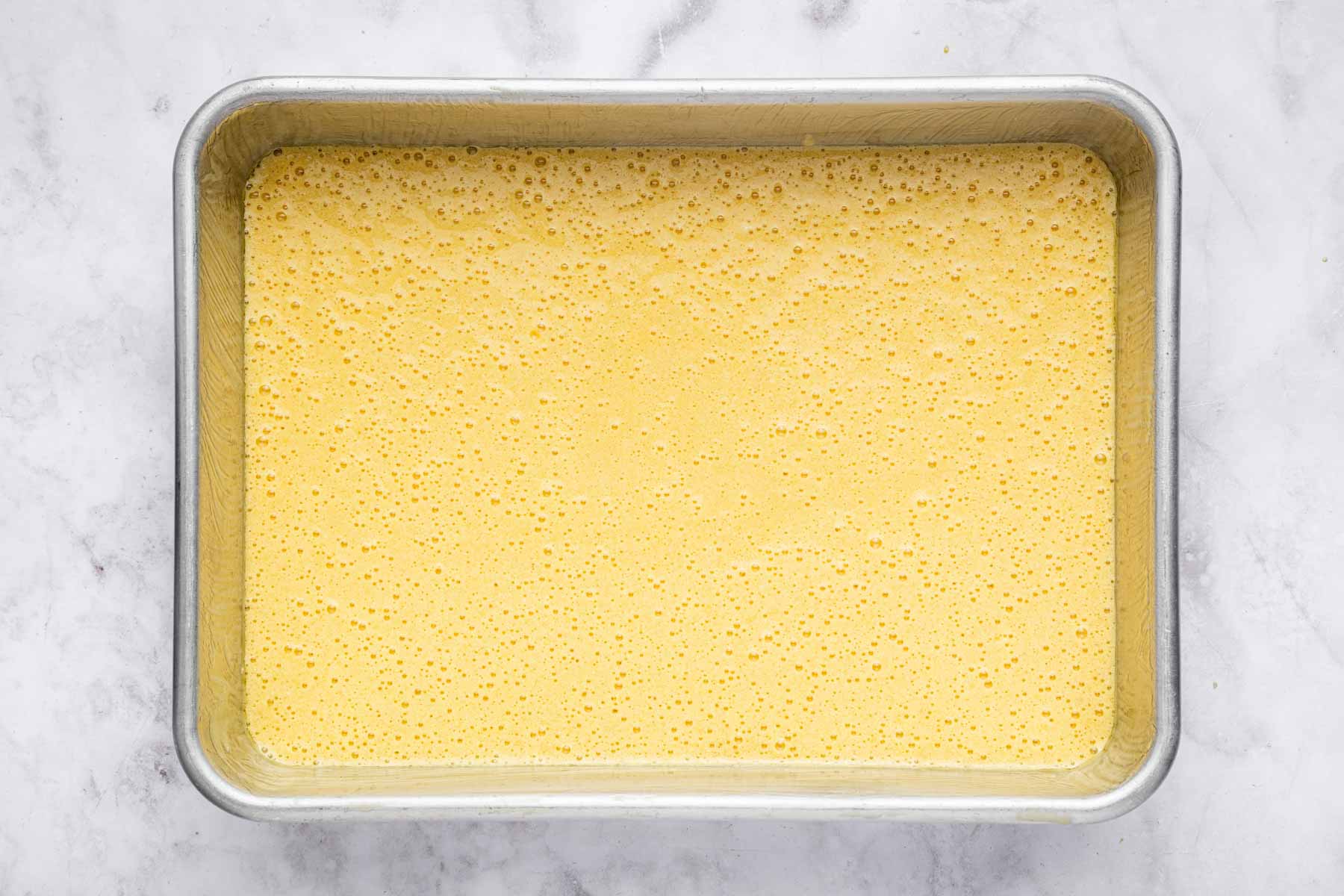 Yellow batter in a 9x13-inch pan, unbaked.
