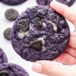 Hand holding an ube cookie with crushed Oreos in it.