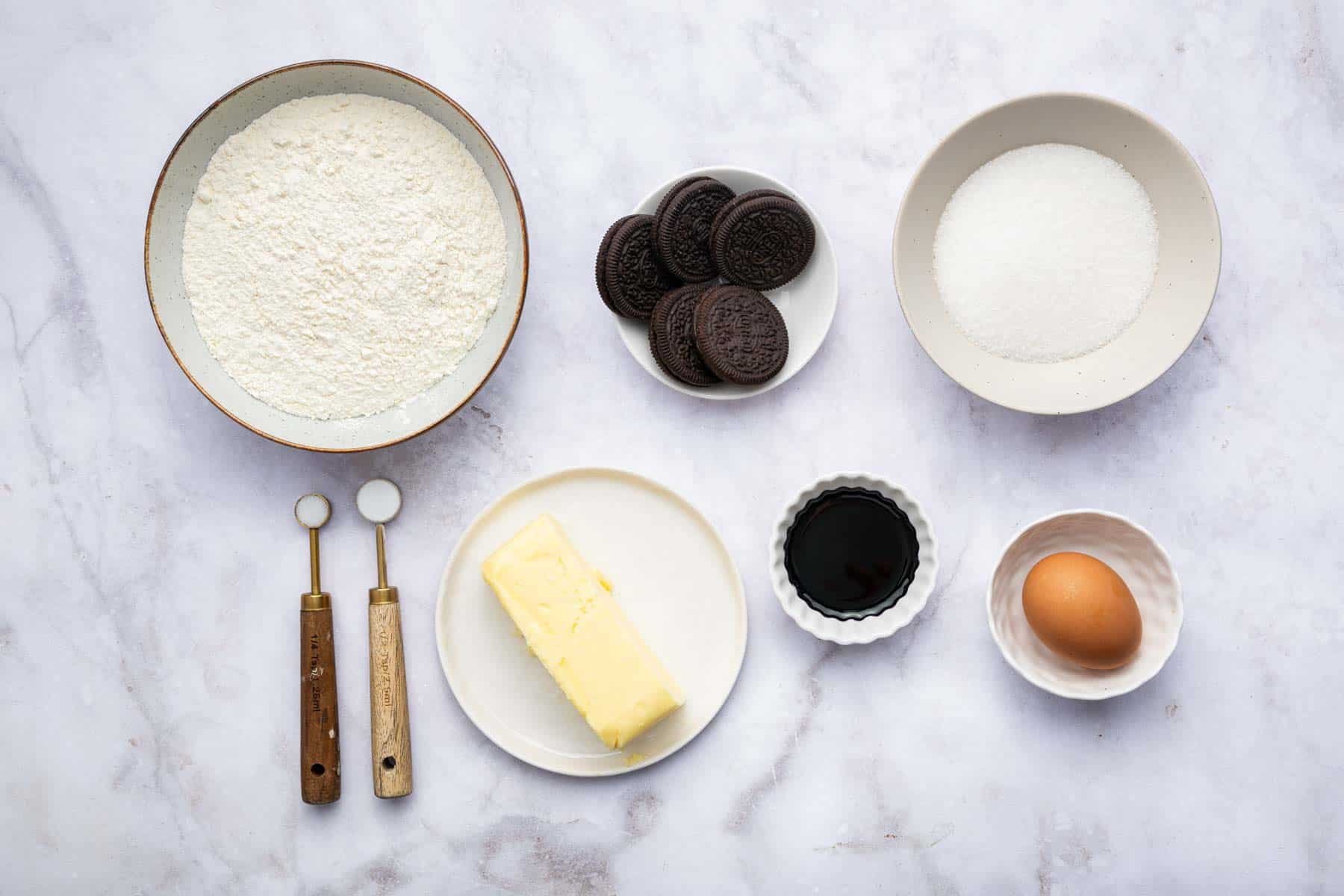 Little bowls of flour, sugar, and purple food coloring.