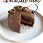 small chocolate cake on grey plate with slice missing