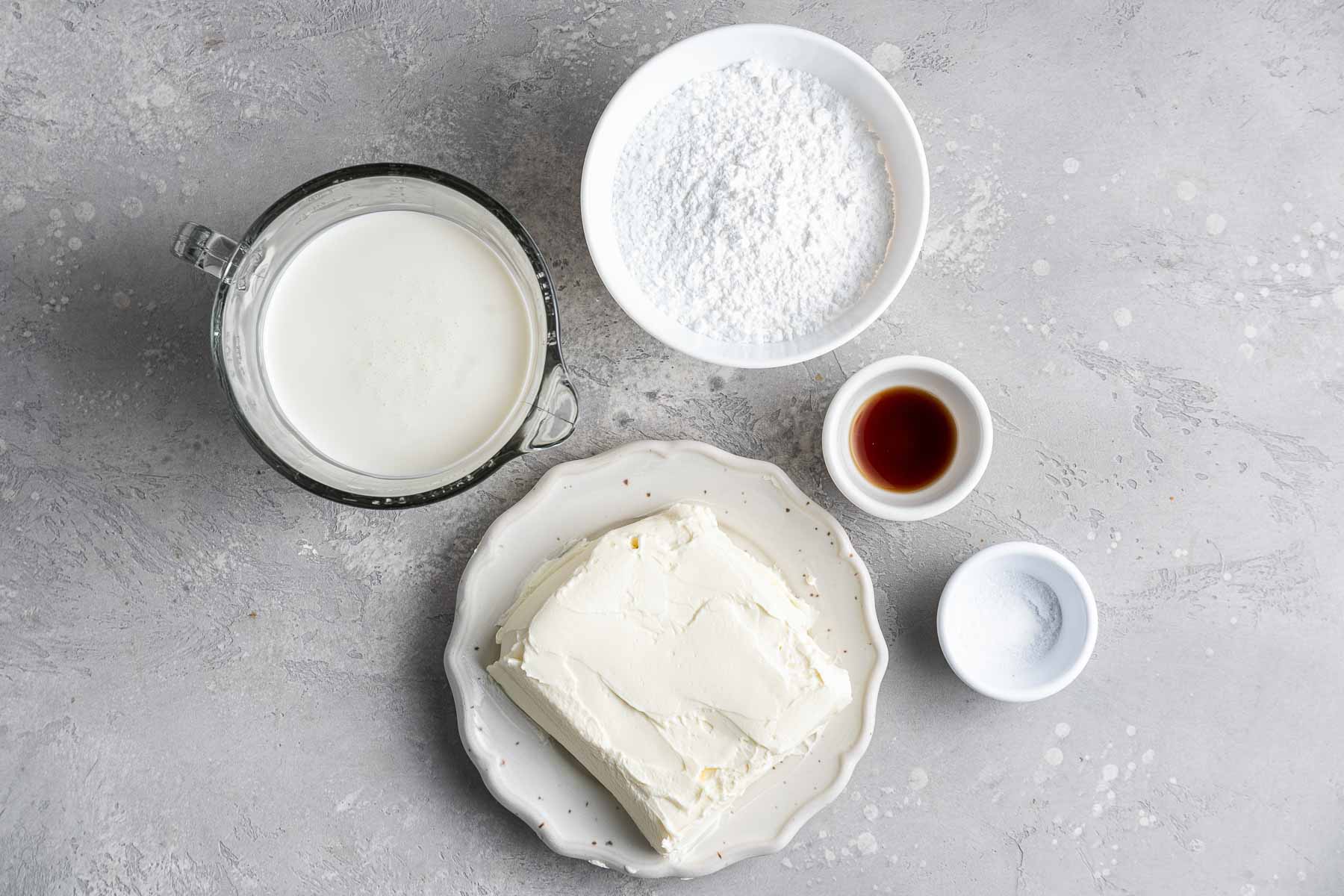 Cream cheese, sugar, vanilla, salt and whipped cream in small bowls.