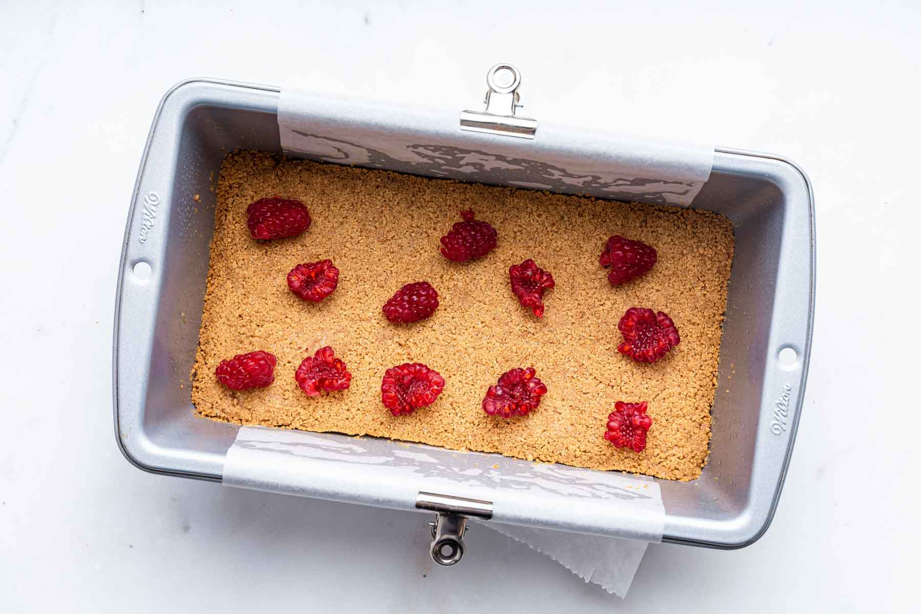 Graham cracker crust with torn berries on top.